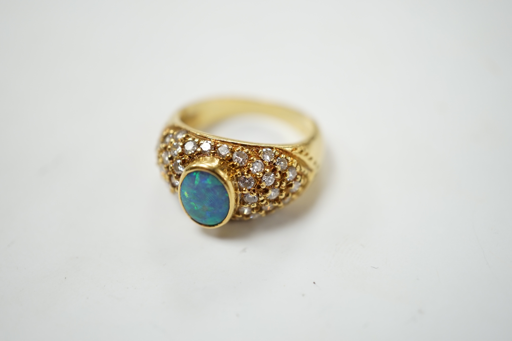 A modern 750 yellow metal and back opal set dress ring with diamond cluster set shoulders, size L, gross weight 6.9 grams. Condition - fair